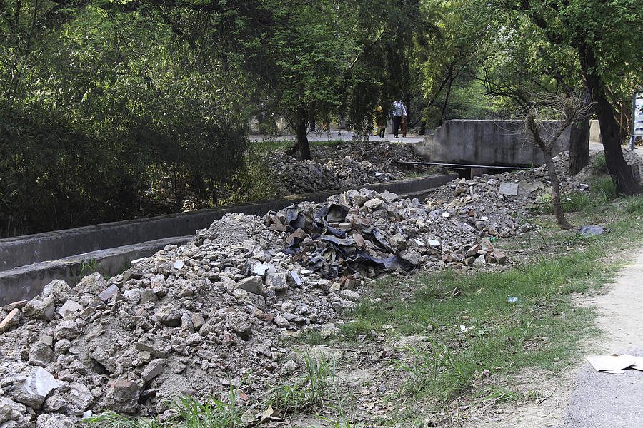 Construction debris on both sides of a drain in the Delhi Zoo #1 Photograph by Ashish Agarwal