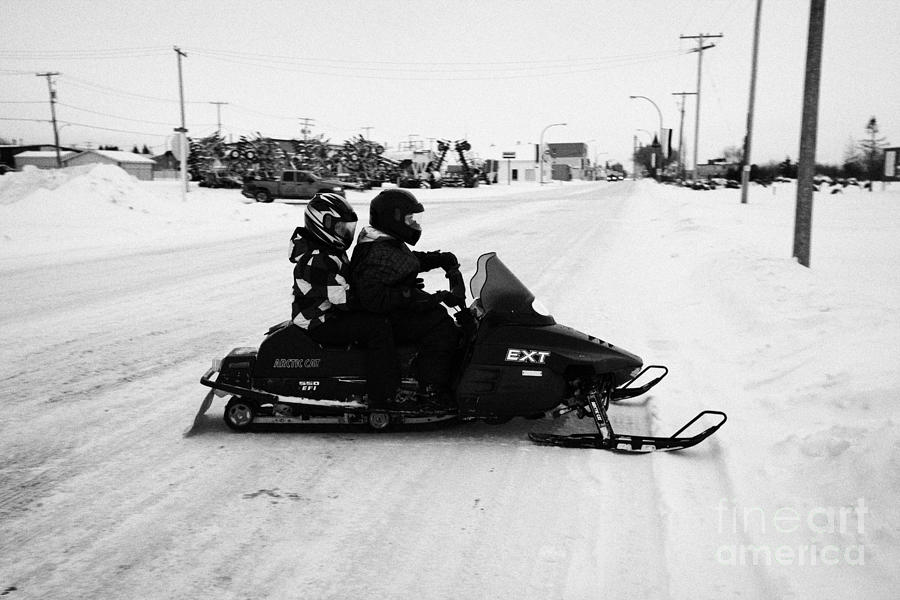 Winter Photograph - couple on a snowmobile Kamsack Saskatchewan Canada #1 by Joe Fox
