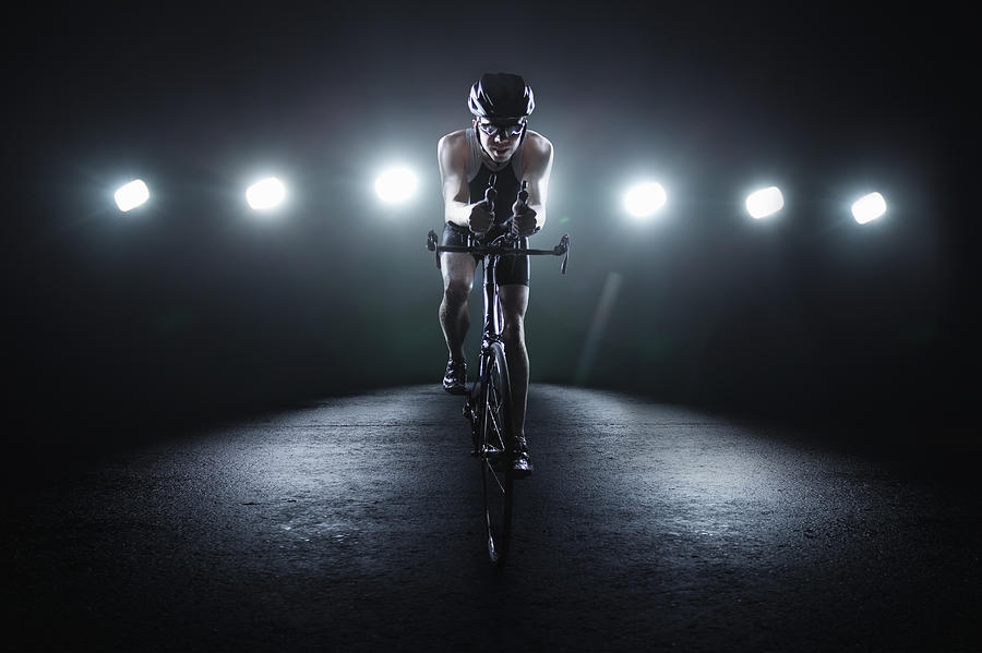 Cyclist Riding At Night In The City #1 Photograph by Stanislaw Pytel