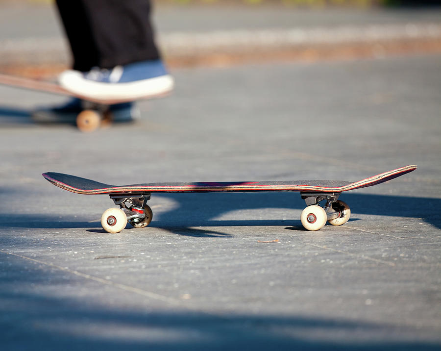 Horizontal Photograph - Detail Of Skateboard And Legs #1 by Panoramic Images