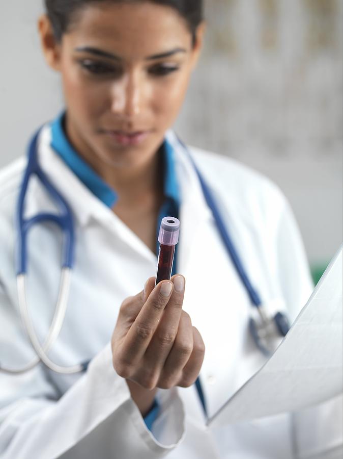 Device Photograph - Doctor holding a blood sample #1 by Science Photo Library