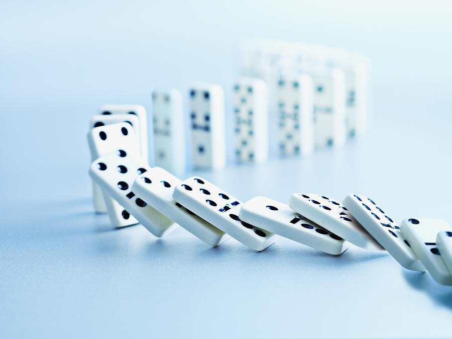 Dominoes falling in a row #1 Photograph by Martin Barraud