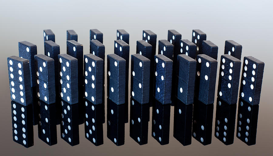 Dominoes standing on reflective surface #1 Photograph by Steven Heap