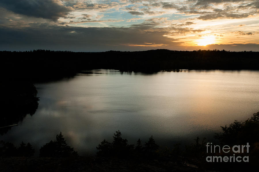 dramatic sky sunset over Aboda Klint lake Sweden #1 Photograph by Peter Noyce