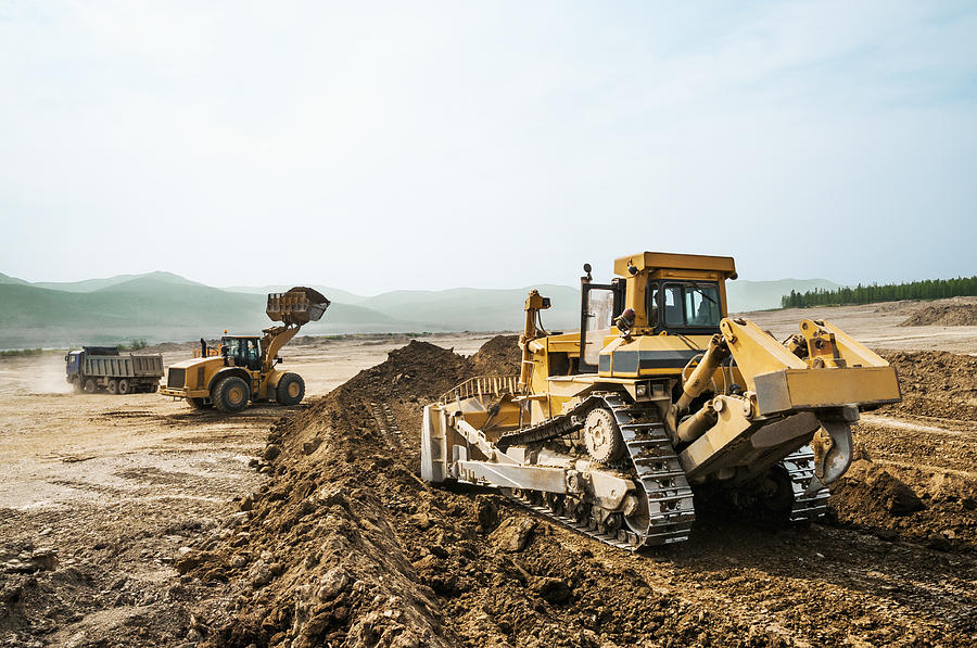 Earthwork, working machinery on a summer day #1 Photograph by Pro-syanov