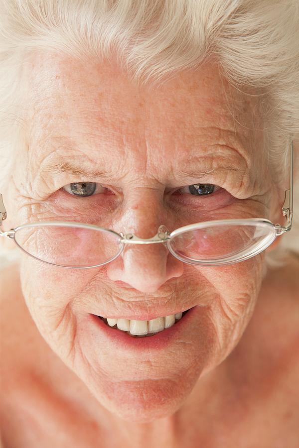 Elderly Woman Using Reading Glasses Photograph By Cristina Pedrazzini