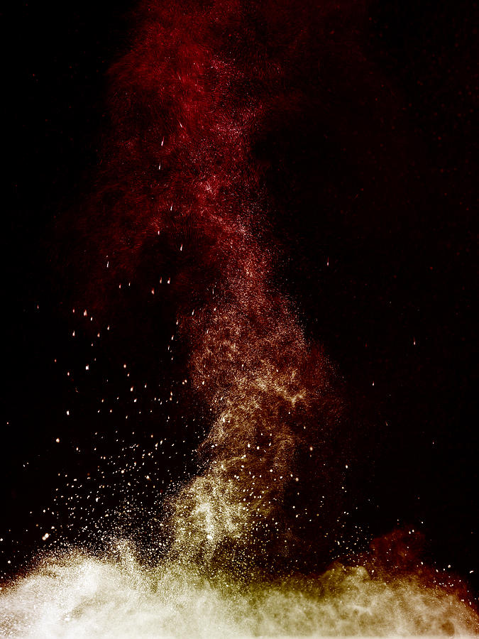 Explosion of a cloud of powder of particles of orange color on a black background #1 Photograph by Jose A. Bernat Bacete