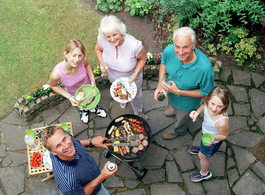 Family Around A Barbecue #1 Photograph by Martin Riedl/science Photo Library