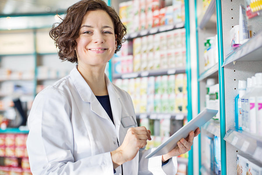 Female pharmacist with a digital tablet #1 Photograph by Alvarez