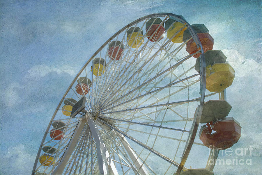 Ferris Wheel rotating upright wheel with passenger cars  #2 Photograph by David Zanzinger