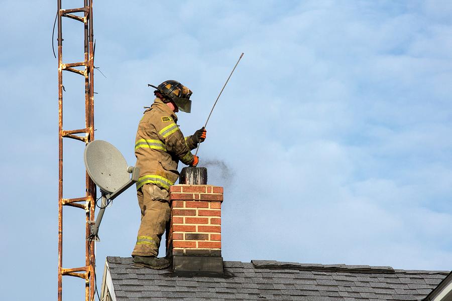 Firefighter Fighting A Chimney Fire #1 Photograph by Jim West
