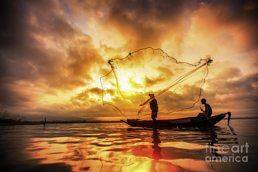 Fisherman of Bangpra Lake in action when fishing #1 Photograph by Anek Suwannaphoom