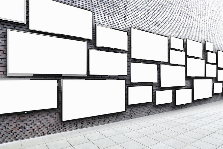Flat screens hanging on a wall #1 Photograph by Jorg Greuel