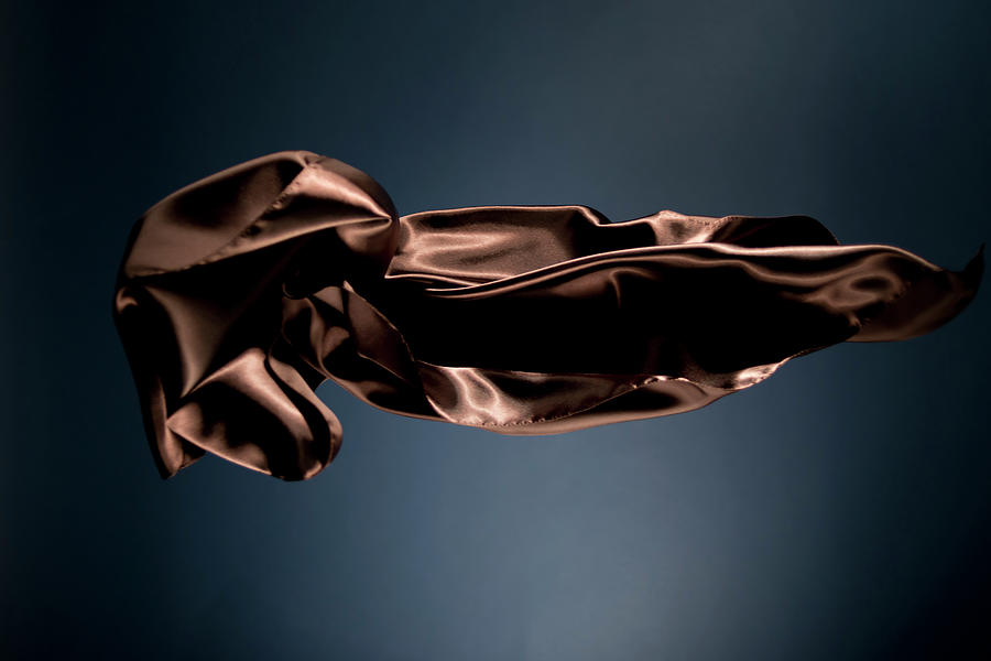 Floating Brown Satin On A Dark Blue #1 Photograph by Gm Stock Films