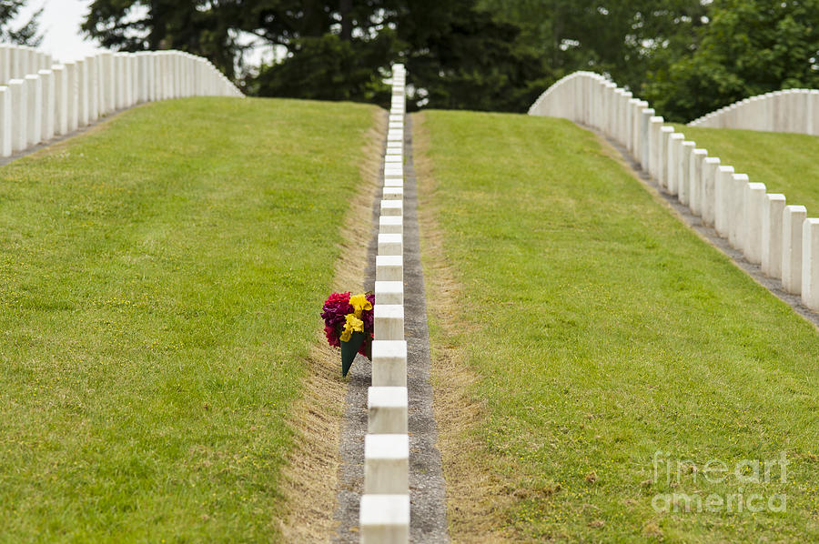 Flowers placed at soldiers gravesite #1 Photograph by Jim Corwin