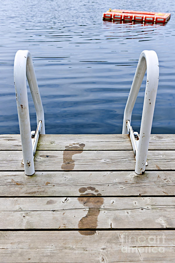 Footprints on dock at summer lake 1 Photograph by Elena Elisseeva