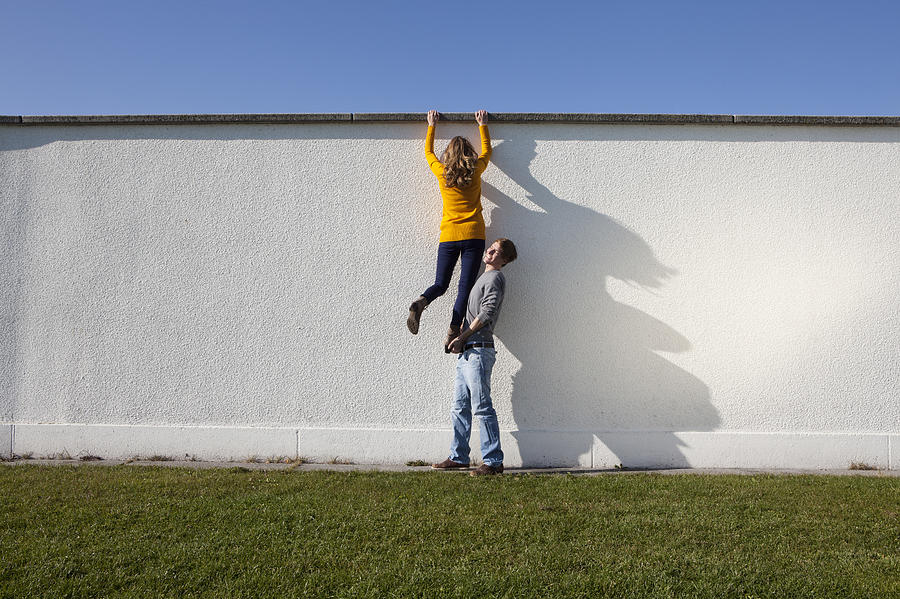 Germany, Bavaria, Munich, Young couple climbing wall #1 Photograph by Westend61