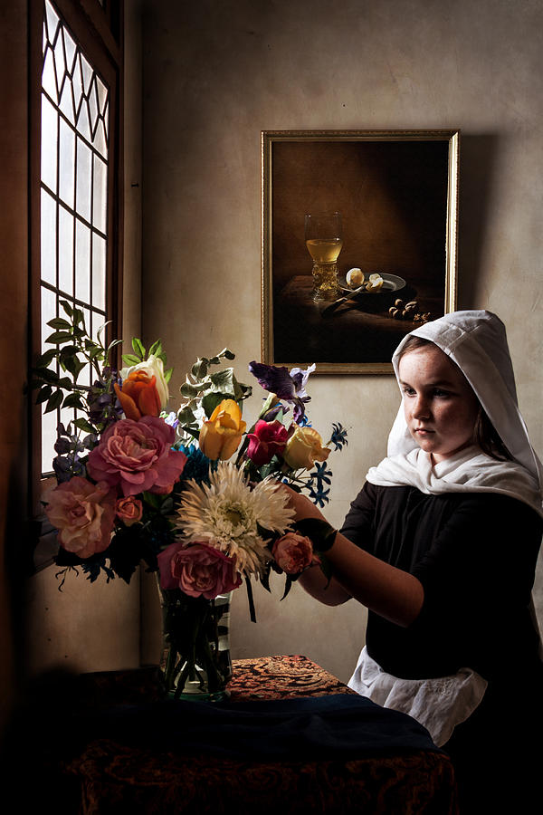 Jan Vermeer Photograph - Girl arranging a flower bouquet in a glass vase #1 by Levin Rodriguez