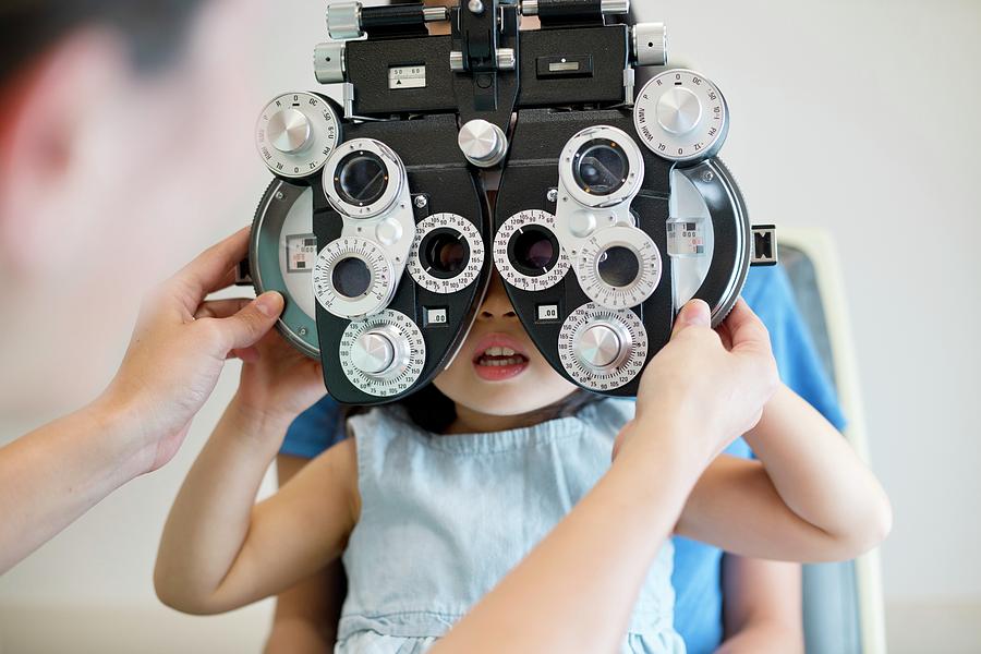 Girl Having Her Eyes Tested #1 Photograph by Science Photo Library