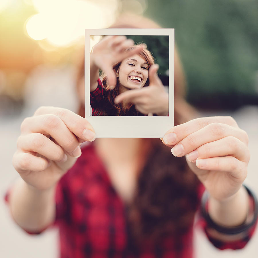 Girl holding instant selfie #1 Photograph by Martin-dm