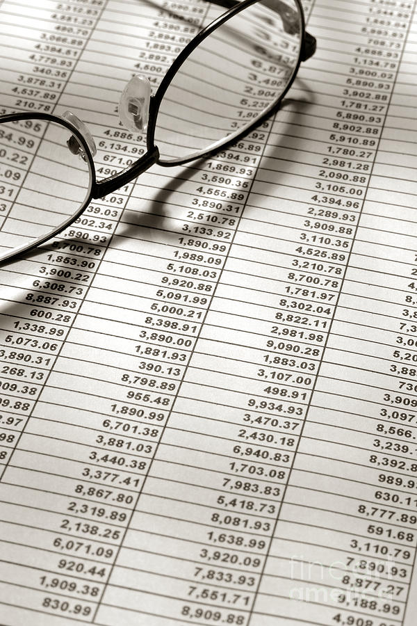 Glasses on Financial Spreadsheet Photograph by Olivier Le Queinec