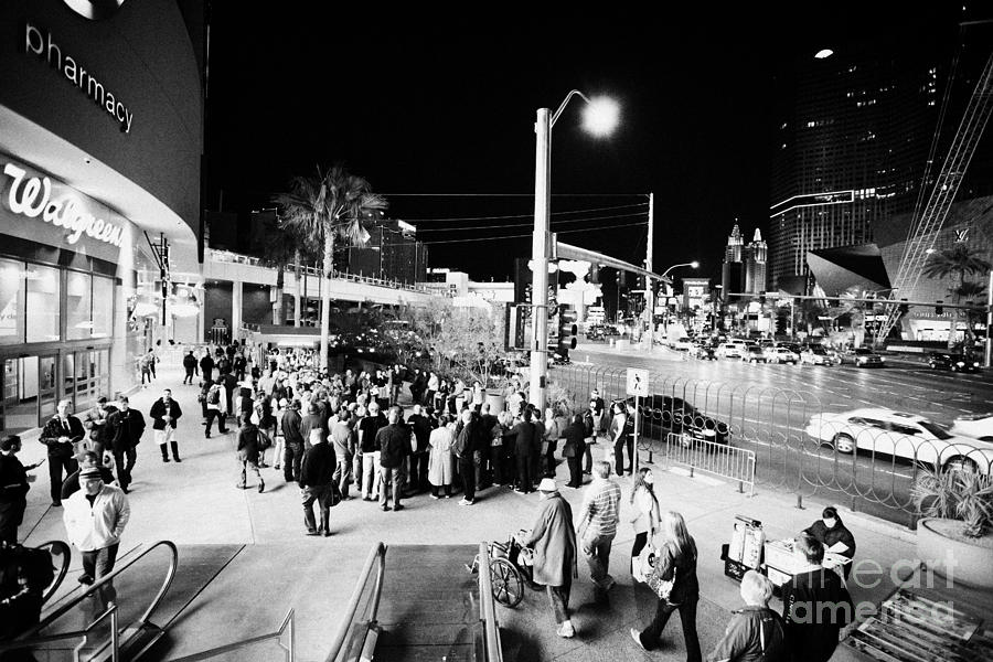 Las Vegas Photograph - Going Down Escalator To Crowd Around Street Entertainer At Night Las Vegas Boulevard Nevada Usa #1 by Joe Fox