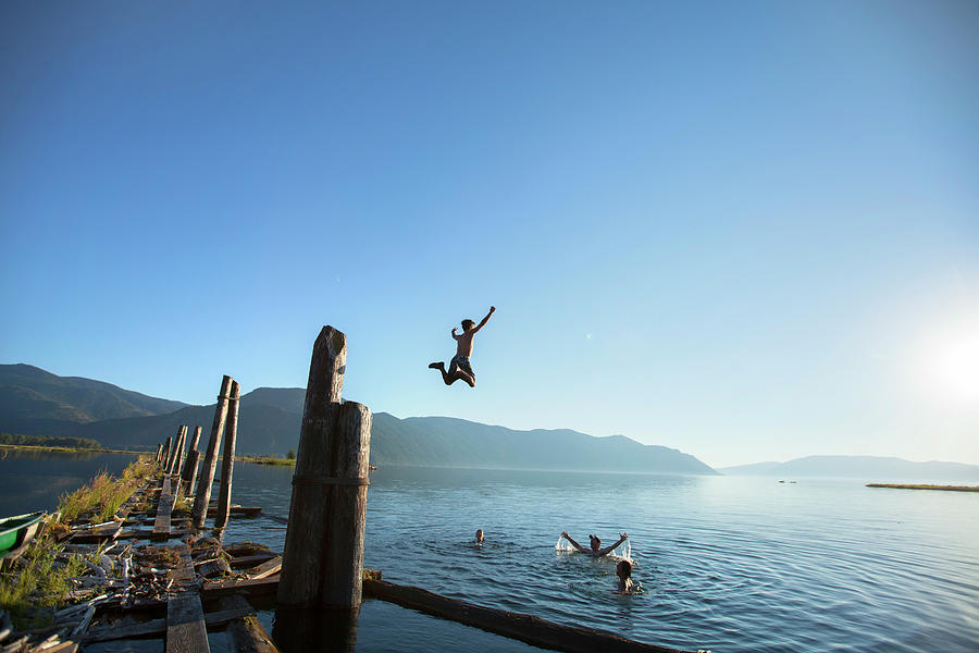 Group Of Friends Swimming And Jumping Photograph By Woods Wheatcroft ...