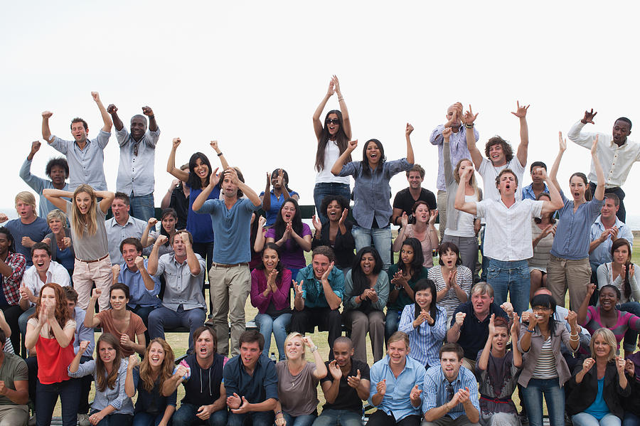 Group of spectators cheering #1 Photograph by Martin Barraud