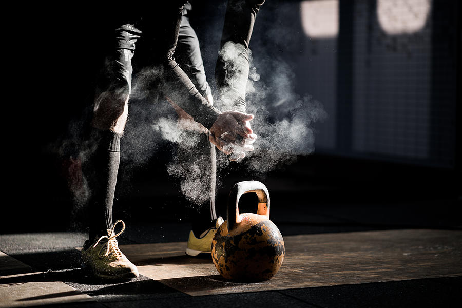 Gym fitness workout: Man ready to exercise with kettle bell #1 Photograph by Ilbusca