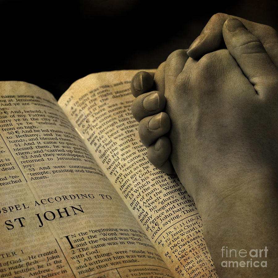 Hands Praying On Bible Photograph