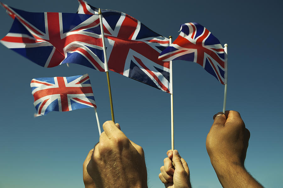 Hands Wave Union Jack British Flags Blue Sky #1 Photograph by PeskyMonkey