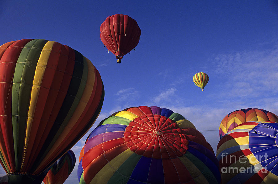 Hot air ballons lifting off #1 Photograph by Jim Corwin