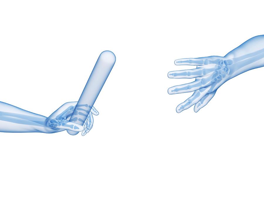 Human Hand Passing Relay Baton #1 Photograph by Sebastian Kaulitzki