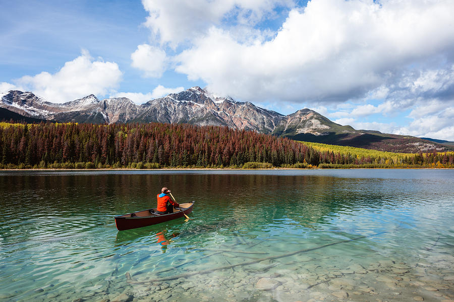Man canoeing on lake, Jasper National Park, Canada #1 Photograph by Matteo Colombo