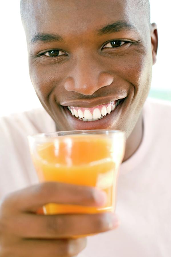 Man Drinking Orange Juice #1 Photograph by Ian Hooton/science Photo Library