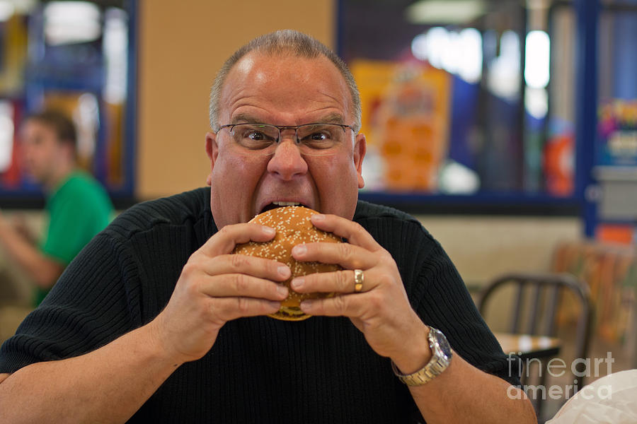 Man Eating Burger In Fast Food Restaurant Photograph By Gunter Nezhoda Pixels