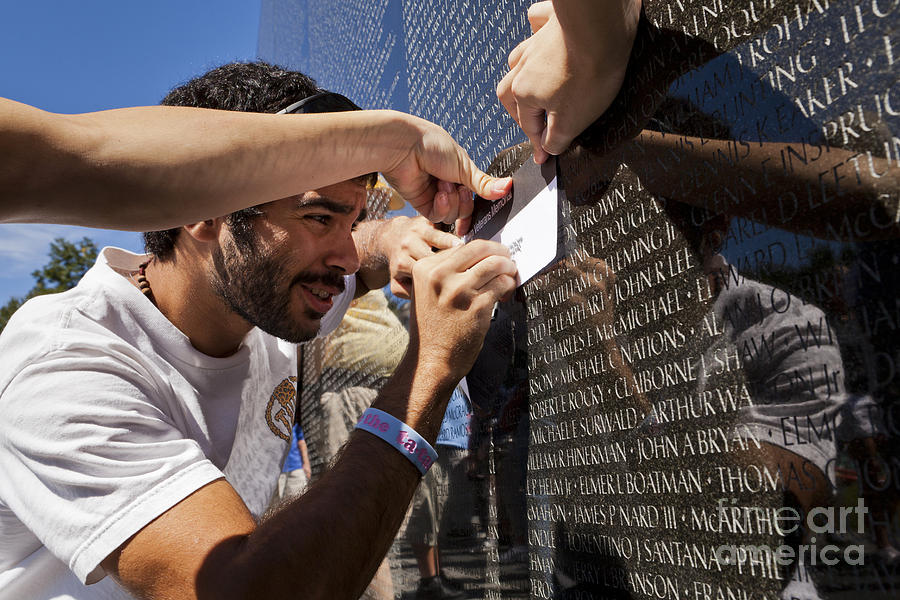 Vietnam Photograph - Man getting a rubbing of fallen soldiers name at the Vietnam War Memorial #1 by B Christopher