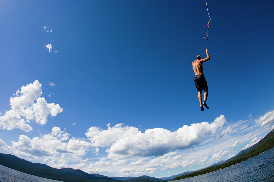Man Jumping Off Rope Swing Into Lake #1 Photograph by Gabe Rogel