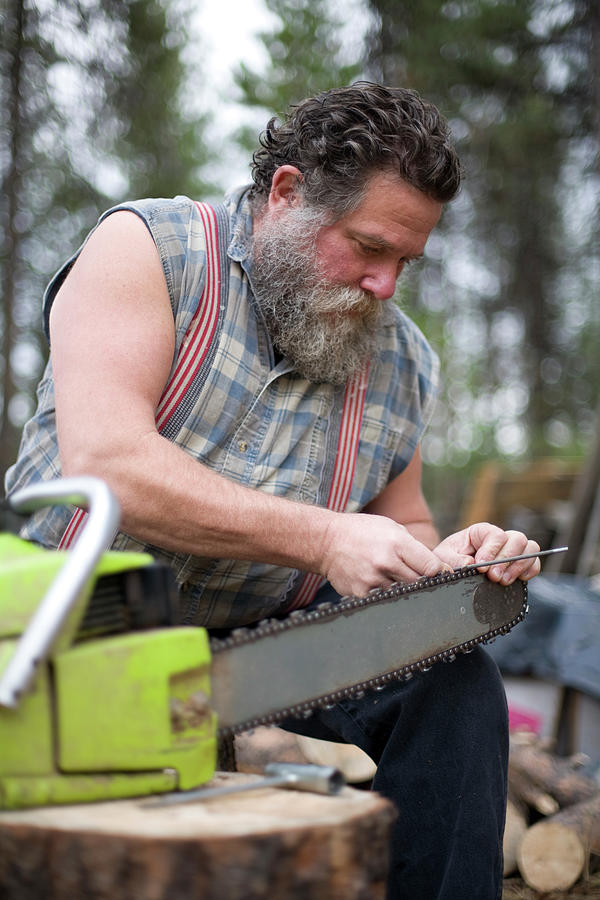 Man Sharpening Chainsaw Photograph By Heath Korvola