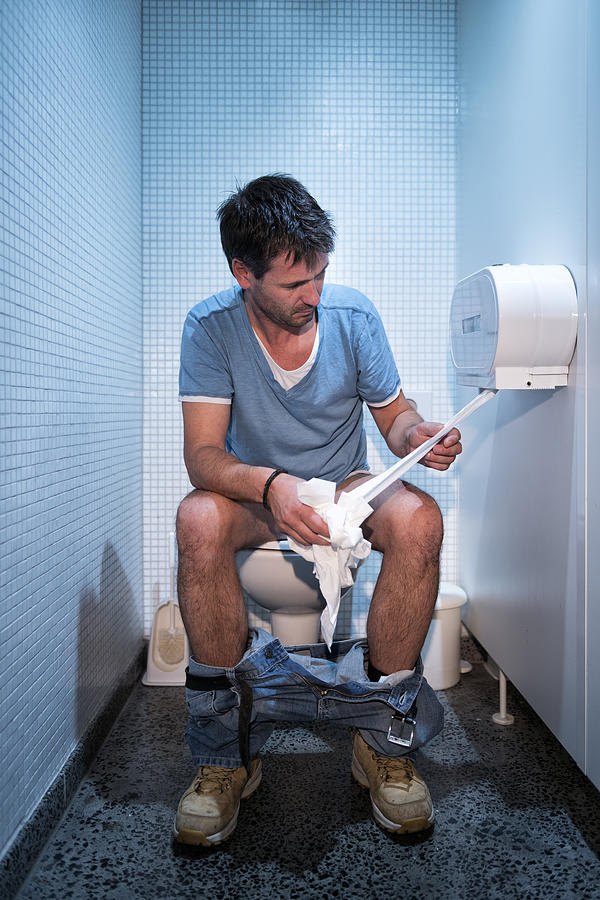 Man Sitting In Public Restroom #1 Photograph by Kemter
