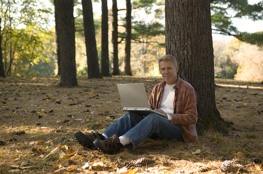Man using laptop outdoor #1 Photograph by Comstock Images