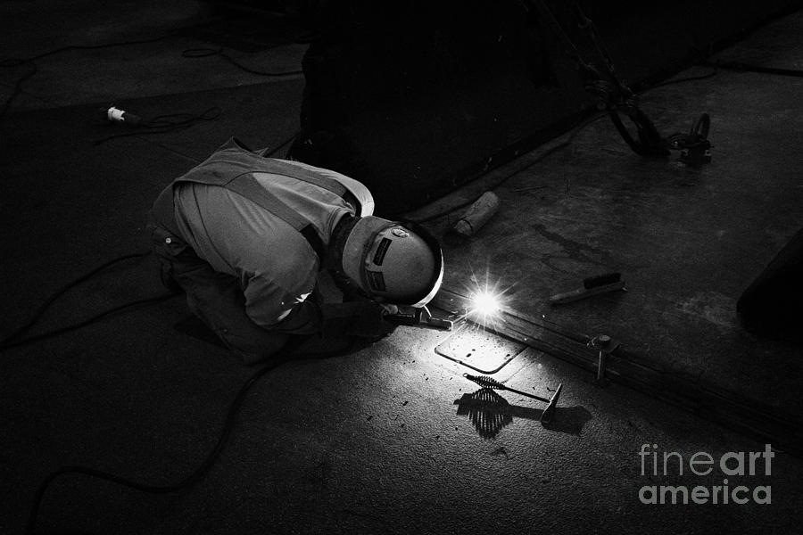 man welding metal plates together on the street Las Vegas Nevada USA