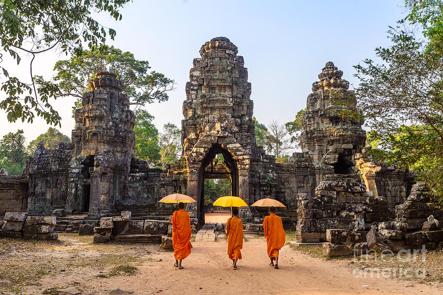 Monks with umbrella walking into Angkor Wat temple - Cambodia #1 Photograph by Matteo Colombo