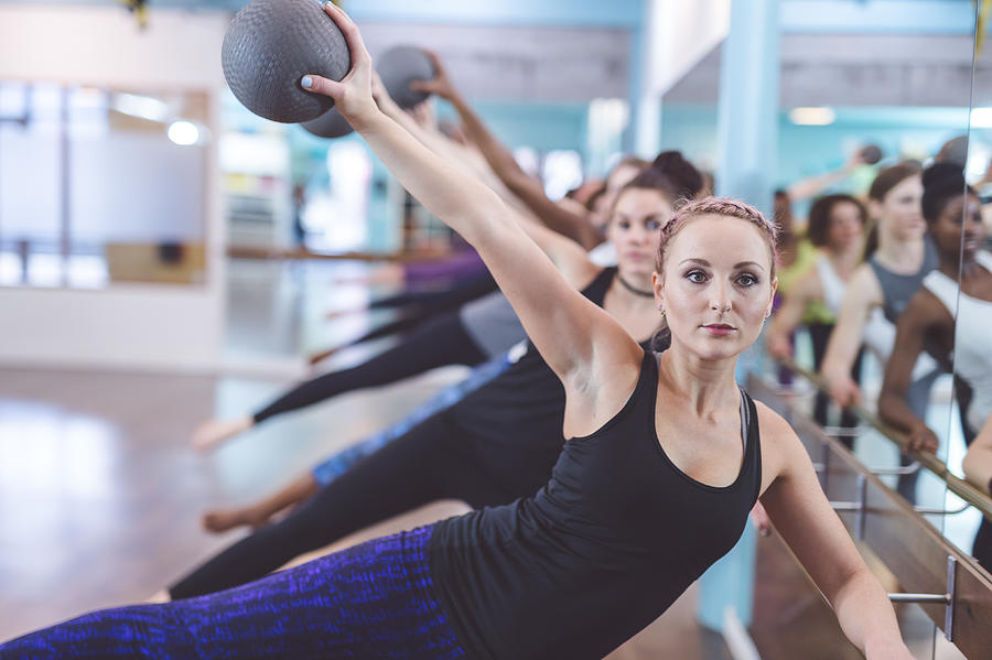 Multi-ethnic group of women doing barre workout #1 Photograph by FatCamera