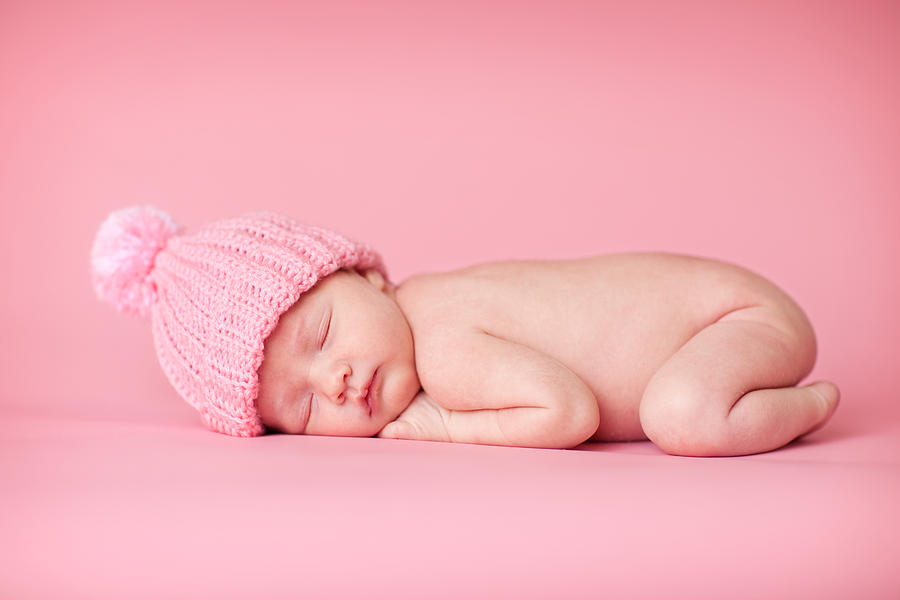 Newborn Baby Girl Sleeping Peacefully on Pink Background #1 Photograph by Ideabug