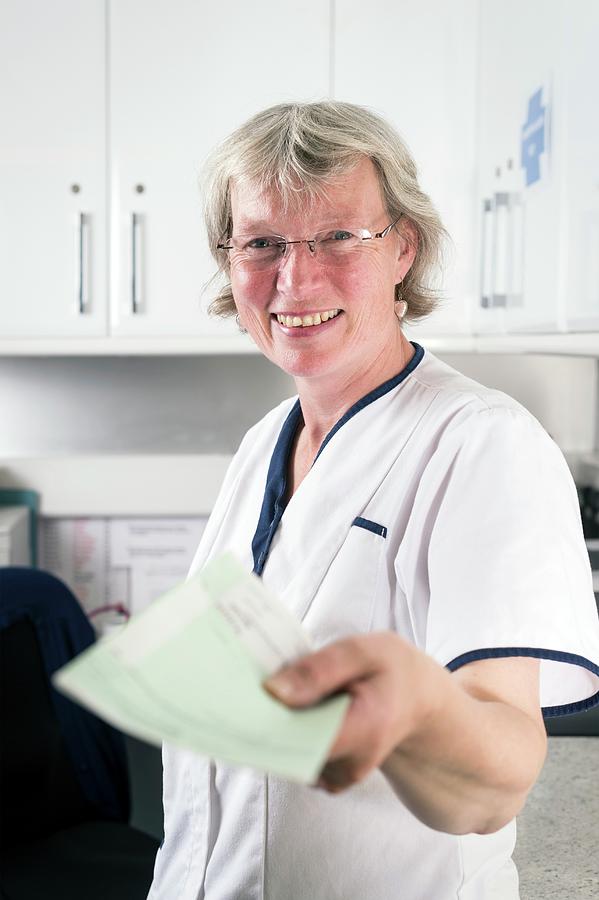 Nurse Handing Out Prescription #1 Photograph by Jim Varney