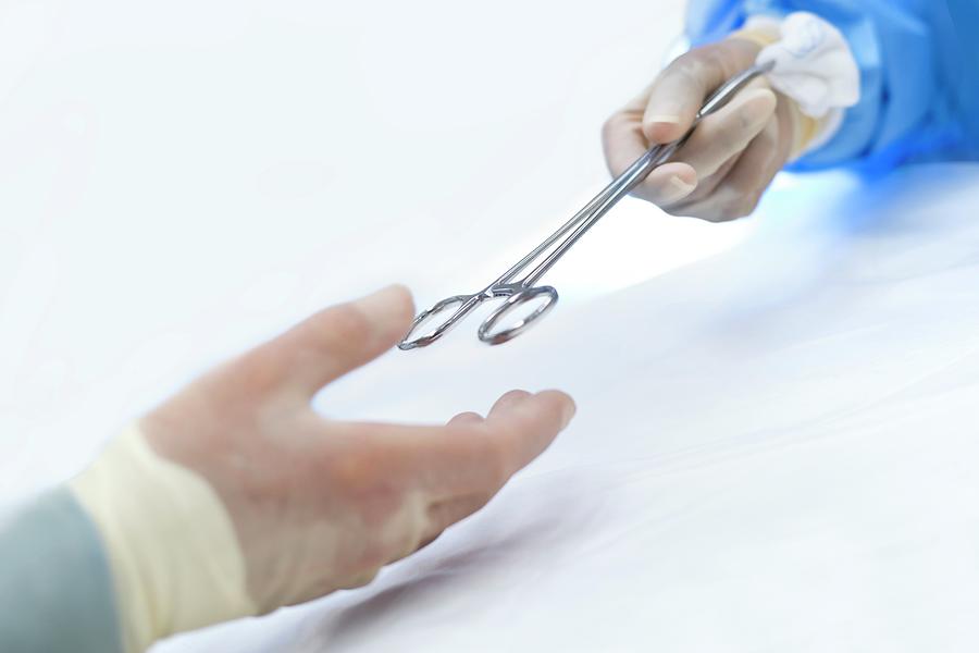 Nurse Passing Surgical Scissors To Surgeon #1 Photograph by Science Photo Library