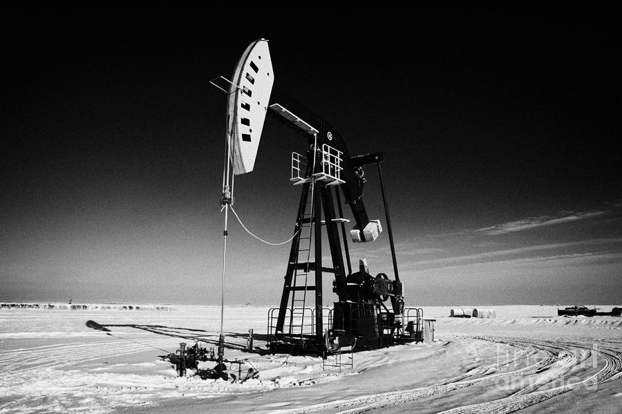 Winter Photograph - oil pumpjack in winter snow Forget Saskatchewan Canada #1 by Joe Fox