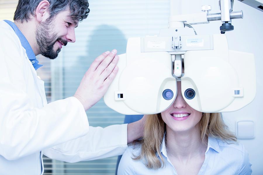 Optometrist Performing Eye Test #1 Photograph by Science Photo Library
