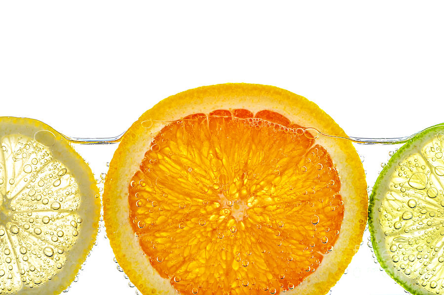 Orange lemon and lime slices in water 1 Photograph by Elena Elisseeva